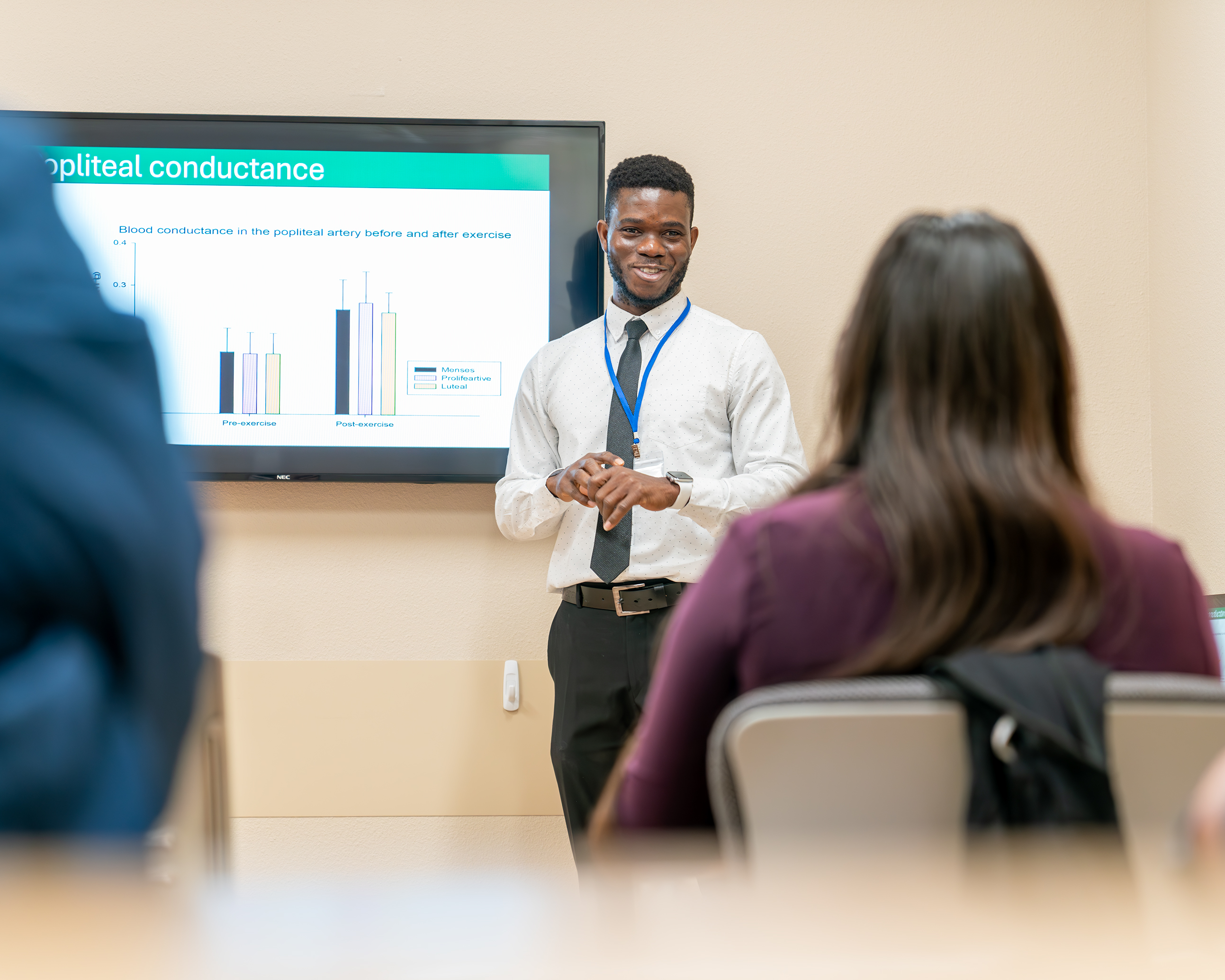 researcher talking to group about research